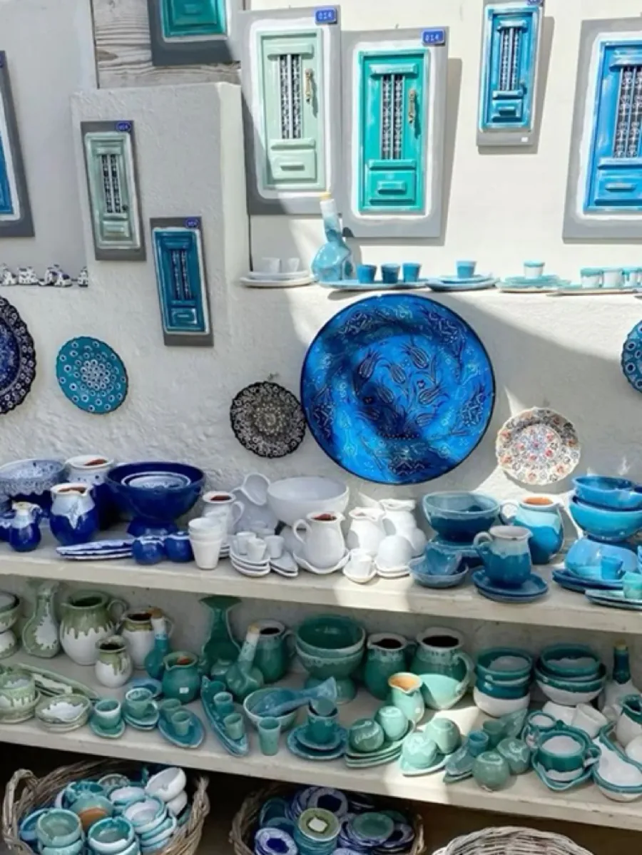 Shelves of blue and teal handmade ceramic tableware